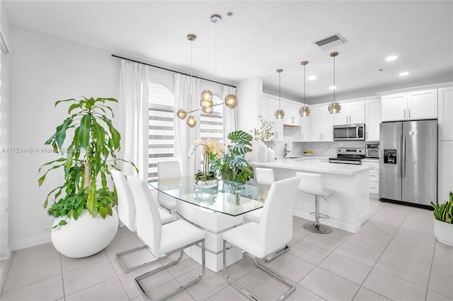 dining room with visible vents, baseboards, a toaster, recessed lighting, and light tile patterned flooring