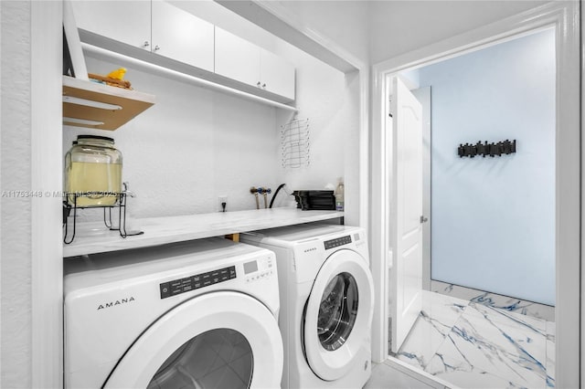 laundry room with laundry area, marble finish floor, and washing machine and clothes dryer