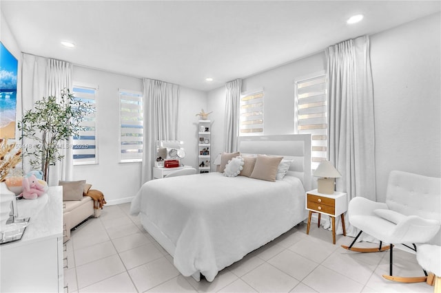 bedroom with baseboards, light tile patterned flooring, and recessed lighting