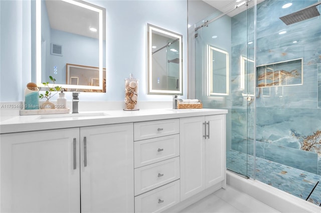 bathroom featuring a stall shower, visible vents, a sink, and double vanity