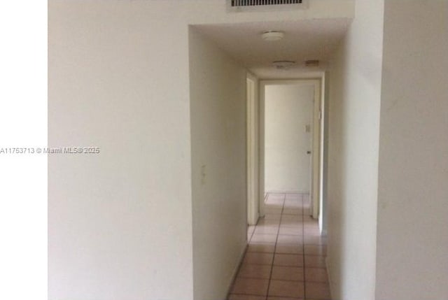 hall with light tile patterned floors and visible vents