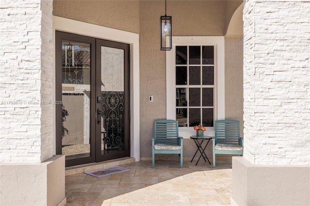 doorway to property with french doors and brick siding