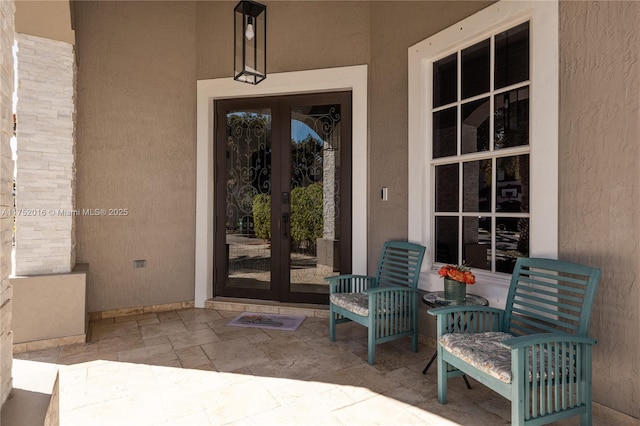 property entrance with french doors and stucco siding