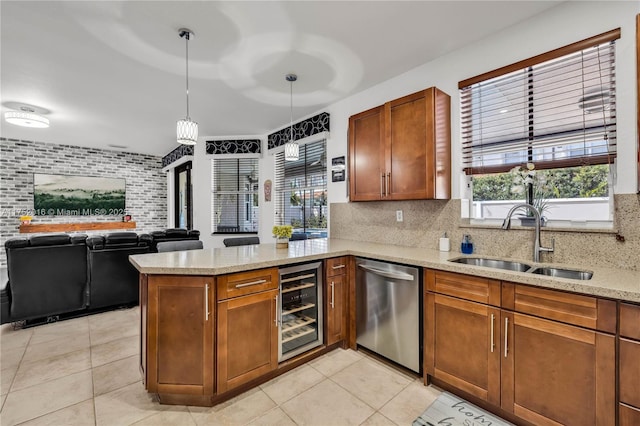 kitchen featuring wine cooler, decorative backsplash, stainless steel dishwasher, a sink, and a peninsula