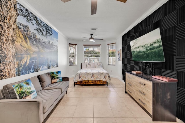 bedroom with crown molding, light tile patterned floors, visible vents, ceiling fan, and baseboards