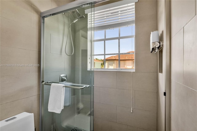 bathroom with a stall shower and toilet