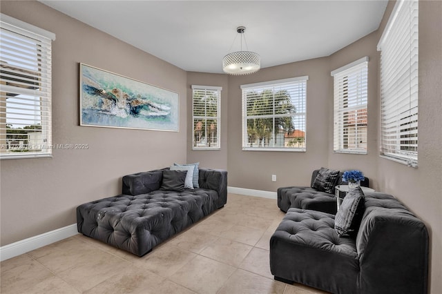 sitting room featuring a wealth of natural light, baseboards, and light tile patterned floors