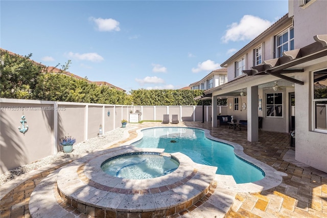 view of pool with a patio area, a fenced backyard, a pool with connected hot tub, and ceiling fan