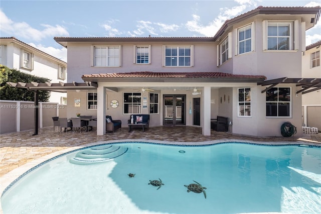 back of property featuring a patio area, fence, a fenced in pool, and stucco siding