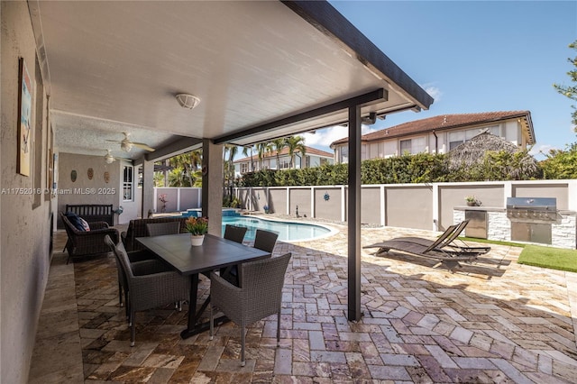 view of patio / terrace featuring a fenced in pool, grilling area, area for grilling, outdoor dining space, and a fenced backyard