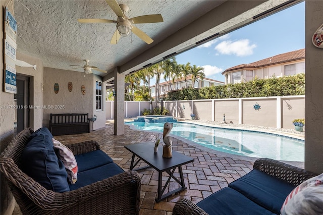 view of pool featuring a fenced backyard, a pool with connected hot tub, and a patio