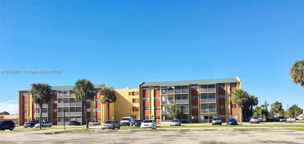 view of building exterior with uncovered parking