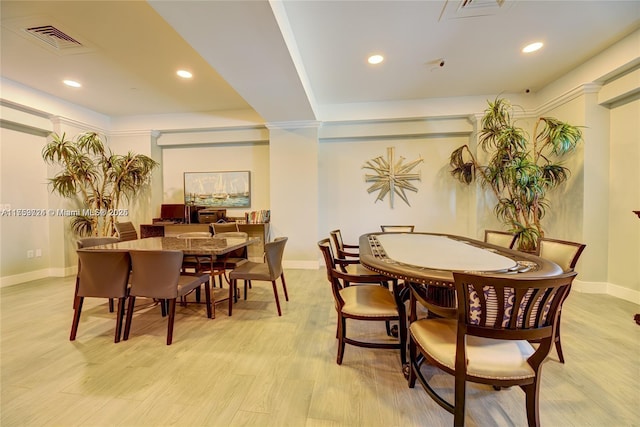 dining room featuring light wood finished floors, baseboards, visible vents, and recessed lighting