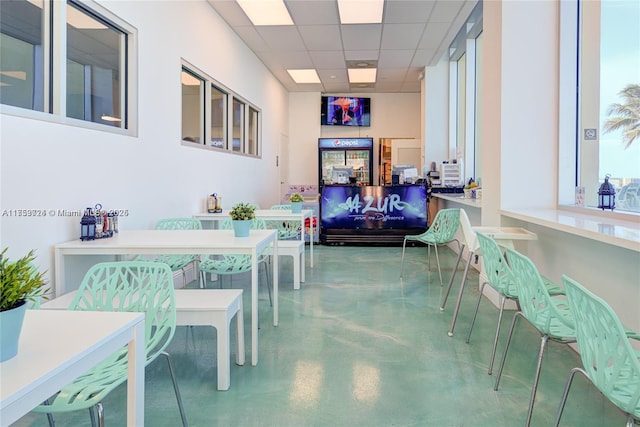 interior space with concrete floors and a drop ceiling