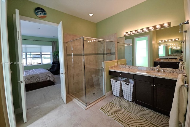 full bathroom with tile patterned floors, a stall shower, vanity, and ensuite bathroom