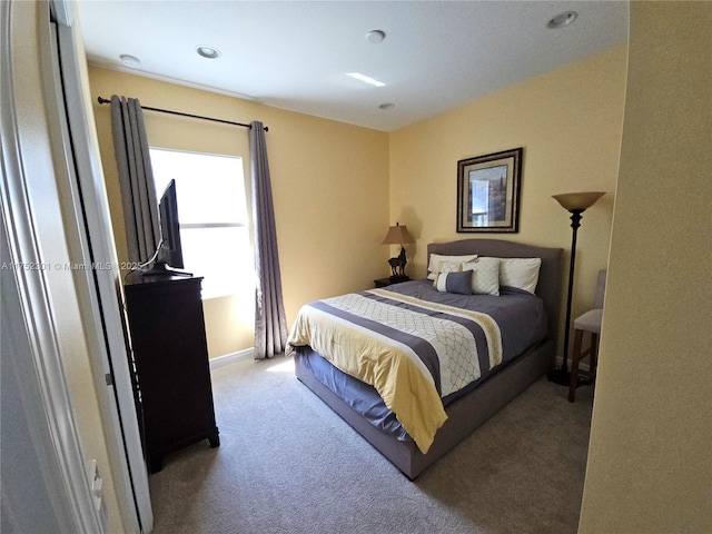 bedroom with carpet flooring and baseboards