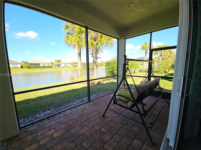 sunroom / solarium with a water view