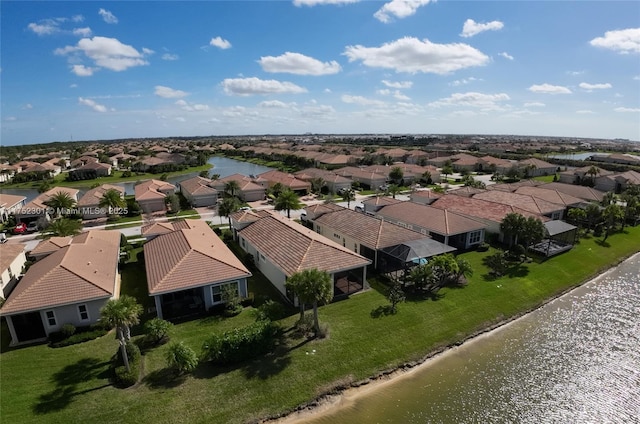 drone / aerial view with a residential view and a water view