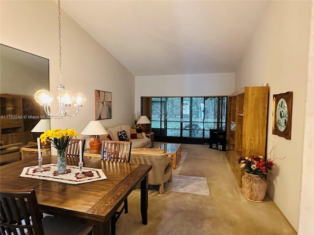 dining room featuring high vaulted ceiling and a chandelier