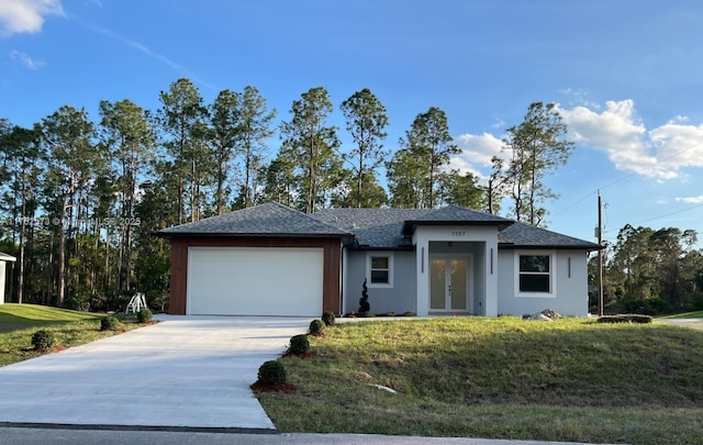 view of front of property featuring a garage, french doors, a front lawn, and concrete driveway