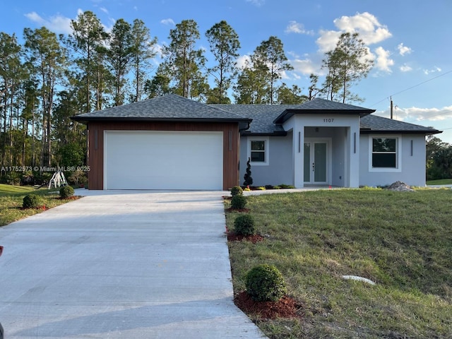 view of front of property with a garage, concrete driveway, roof with shingles, french doors, and a front yard