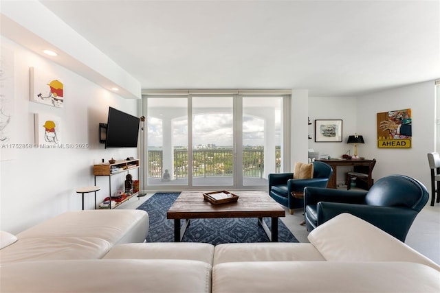 living area featuring expansive windows and recessed lighting