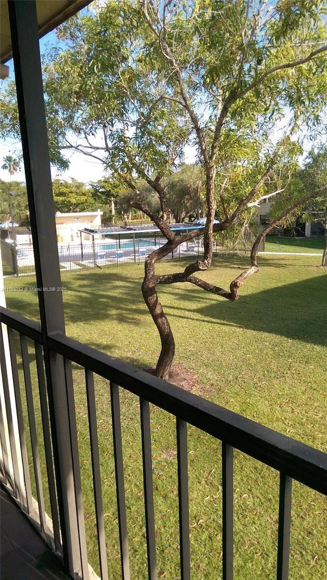 view of yard with fence and a fenced in pool