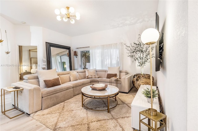 living room featuring light wood finished floors and a notable chandelier