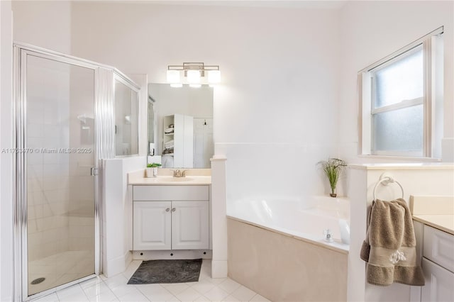 bathroom with a bath, a stall shower, vanity, and tile patterned floors