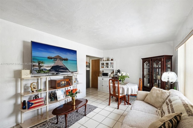 living room featuring a textured ceiling and light tile patterned flooring