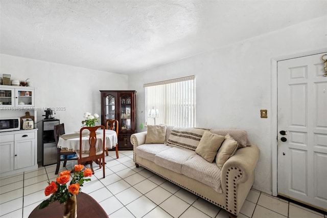 living room featuring a textured ceiling and light tile patterned floors