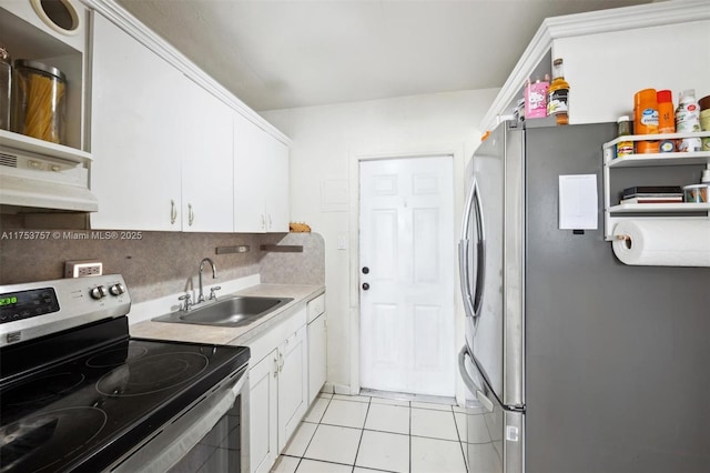 kitchen with stainless steel appliances, a sink, light countertops, and white cabinets