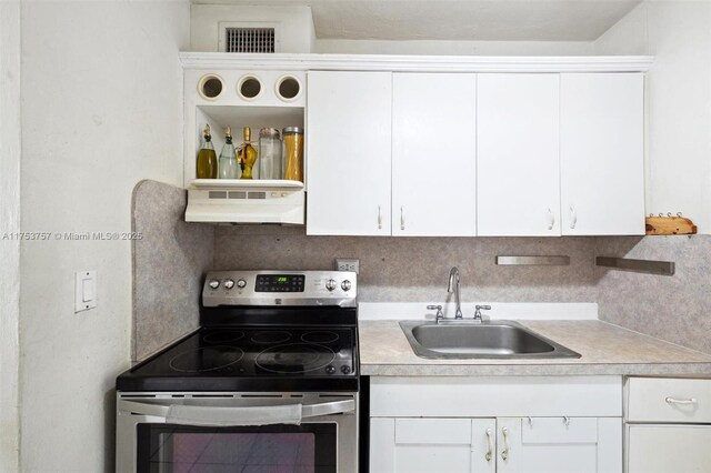 kitchen with light countertops, stainless steel electric range, a sink, and under cabinet range hood