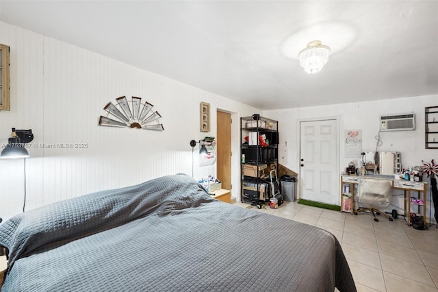 bedroom with a wall mounted AC and light tile patterned floors