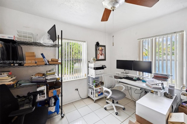 home office with tile patterned flooring, ceiling fan, and a textured ceiling