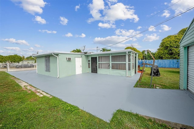 rear view of property featuring a yard, a patio area, fence private yard, and stucco siding