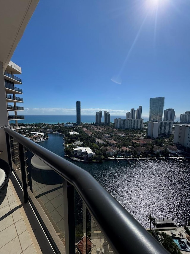 balcony featuring a water view and a city view