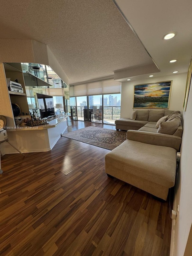 living room with recessed lighting, a textured ceiling, expansive windows, and wood finished floors