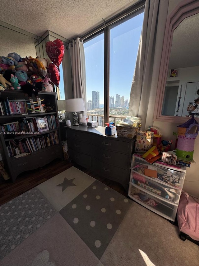 bedroom with a view of city and a textured ceiling