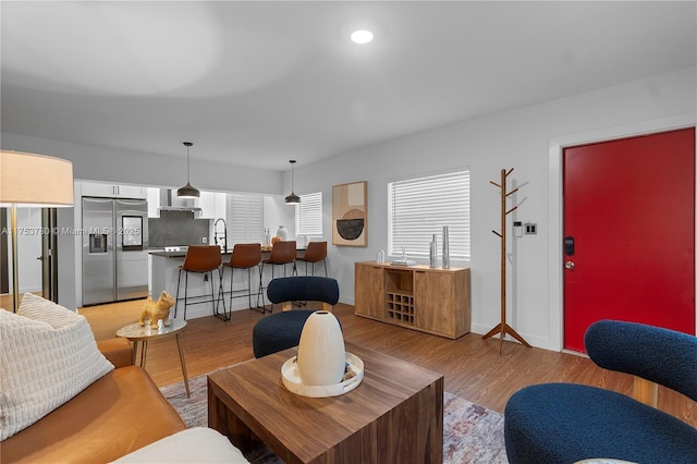 living area featuring recessed lighting and light wood-style flooring