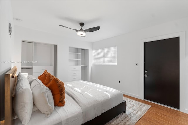 bedroom with light wood-style flooring, baseboards, and a ceiling fan