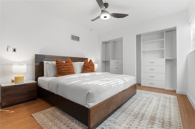 bedroom featuring ceiling fan, baseboards, visible vents, and light wood-type flooring