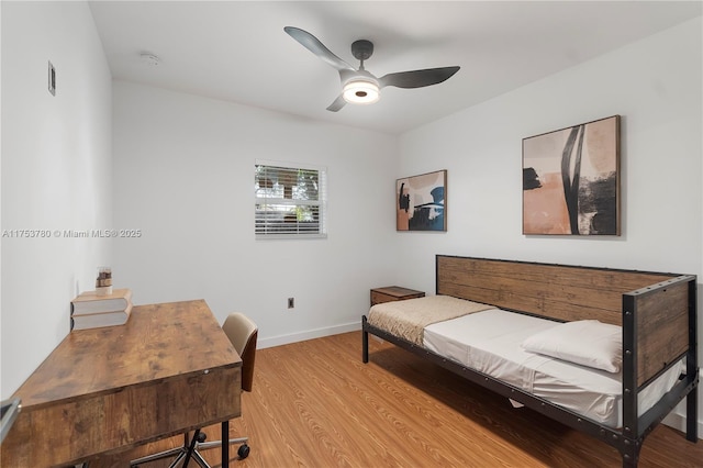 office area with baseboards, light wood-type flooring, and ceiling fan