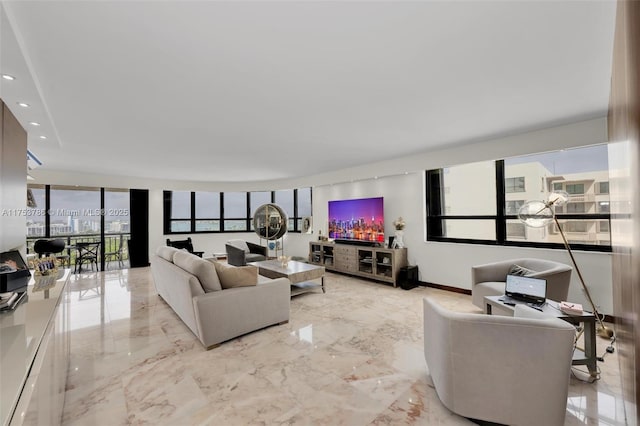 living area featuring baseboards, marble finish floor, and recessed lighting