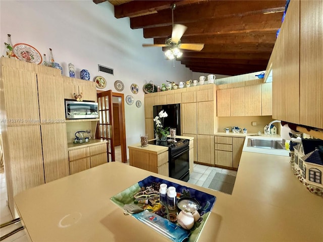 kitchen with light countertops, visible vents, light brown cabinetry, a sink, and black appliances