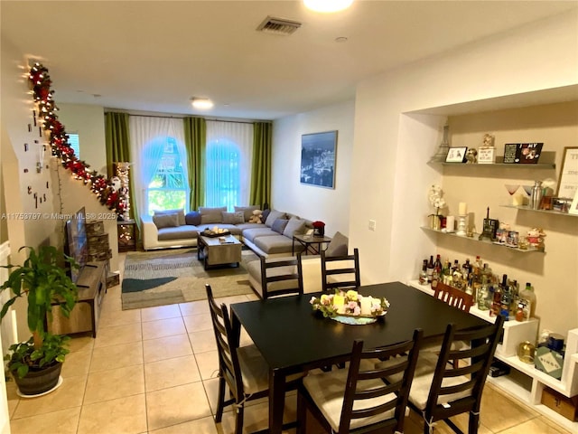 dining space featuring visible vents and light tile patterned floors