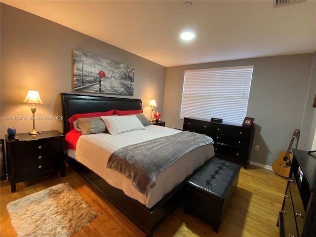 bedroom featuring wood finished floors and baseboards