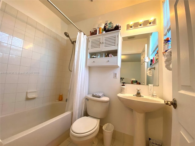 full bathroom featuring shower / tub combo, tile patterned flooring, toilet, and baseboards