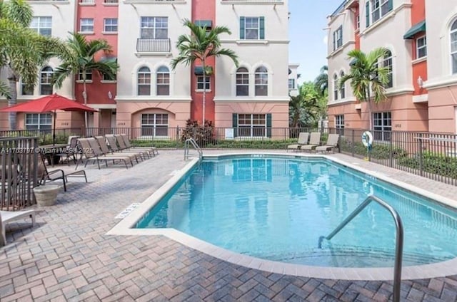 community pool featuring a patio and fence