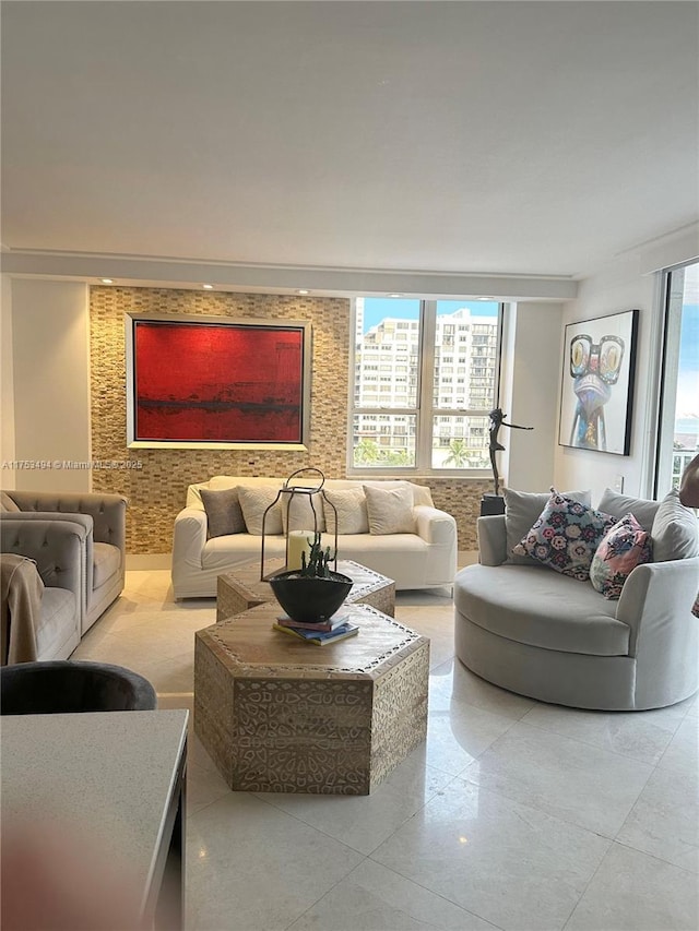 living room featuring a healthy amount of sunlight and an accent wall